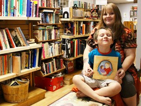 AnneMarie Caron sits with her son, Sage, in Stardust Book Lounge in downtown Sarnia. The 41-year-old author has written a children's book called Never Forget, about how her young son has dealt with his father's death five years ago.  (Chris O’Gorman/ Sarnia Observer)