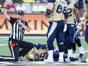 Drew Willy lies on the ground after suffering an apparent leg injury on Sunday. The Bombers won't provide an update on his condition until Tuesday.