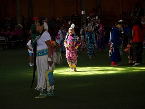 A girl dances through a spot of light in the Crowlodge Arbour in Brocket, Alta., during the Piikani Nation Powwow on Saturday, Aug.1, 2015. John Stoesser photos/Pincher Creek Echo.
