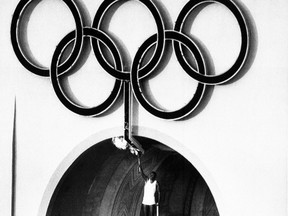 This July 27, 1984, photo, shows 1960 Olympic Decathlon Gold Medallist Rafer Johnson lighting the Olympic torch during the Opening Ceremonies of the 23rd Olympiad in Los Angeles. If Los Angeles becomes the U.S. candidate for the 2024 Olympics, the organizers’ proposed budget for the Summer Games would be $4.1 billion, a senior adviser to Mayor Eric Garcetti said Monday, Aug. 10, 2015. (AP Photo/Files)