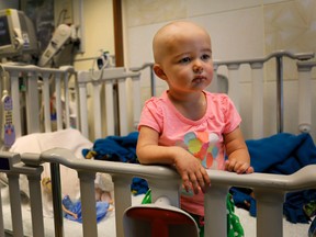 In this June 11, 2015 photo,Talia Pisano stands in her bed at Lurie Children's Hospital in Chicago. Talia is getting tough treatment for kidney cancer that spread to her brain. She's also getting a chance at having babies of her own someday. To battle infertility sometimes caused by cancer treatment, some children’s hospitals are trying a futuristic approach: removing and freezing immature ovary and testes tissue, with hopes of being able to put it back when patients reach adulthood and want to start families. (AP Photo/Christian K. Lee)