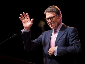 Republican presidential candidate, former Texas Gov. Rick Perry, waves to the crowd as he steps to the podium to speak at the RedState Gathering, Friday, Aug. 7, 2015, in Atlanta. (AP Photo/David Goldman)