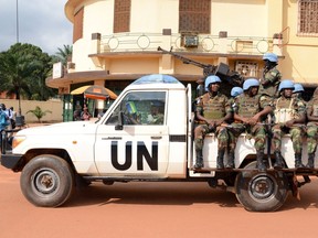 A file photo taken on December 9, 2014 shows UN peacekeeping soldiers from Rwanda patrolling in Bangui, Central African Republic. AFP PHOTO / Pacome PABANDJI/ Files