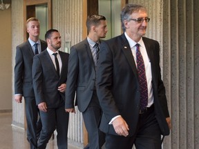 Craig Stoner, Simon Radford and Joshua Finbow, left to right, British sailors charged with sexual assault causing bodily harm while visiting for a hockey tournament earlier in the year, follow lawyer Mark Knox at Nova Scotia Supreme Court in Halifax on Aug. 11, 2015. The men want to return to the United Kingdom pending a preliminary inquiry scheduled for next April. (THE CANADIAN PRESS/Andrew Vaughan)