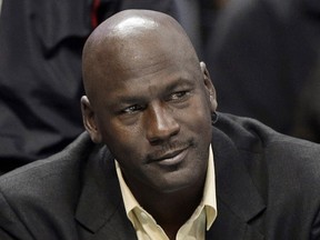 In this April 16, 2014, file photo, Charlotte Bobcats owner Michael Jordan watches an NBA basketball game between the Bobcats and the Chicago Bulls in Charlotte, N.C. (AP Photo/Chuck Burton, File)