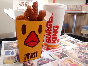 Chicken fries and a soft drink are posed for a photo at a Burger King restaurant, Tuesday, Aug. 11, 2015, in Orlando, Fla. Fans of Burger King's chicken fries may have the boy band One Direction and the website Buzzfeed to thank for the return of the skinny fried sticks. (AP Photo/John Raoux)