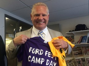Doug Ford shows off the shirts for Ford Fest Camp Day in Toronto on Tuesday August 11, 2015. (Don Peat/Toronto Sun)