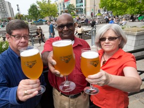 Covent Garden Market general manager Bob Usher, left, Olive?R Twist general manager Siva Markandu  and historic pub tour guide Kym Wolfe enjoy a pint of beer ahead of the Forest City Beer Fest. (CRAIG GLOVER, The London Free Press)