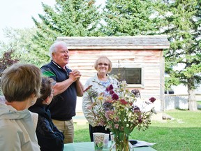 Gerry Teahen and Lorraine Hunter, the Communities and Bloom judges, speak during a thank you dinner for the volunteers at the Kootenai Brown Pioneer Village. John Stoesser photo/Pincher Creek Echo.