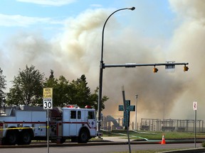 Firefighters hose down a fire at Ecole Frere Antoine School on Millwoods Road and 28 Avenue in Edmonton Tuesday. Perry Mah/Edmonton Sun/Postmedia Network