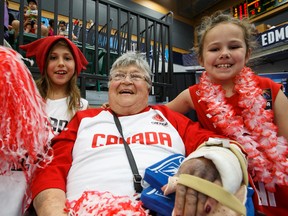 Jean Plouffe, 83, shown here with Raya, left, and Abby Plouffe, both 7, took in Team Canada's opening game at the FIBA Americas Women's Championship on Sunday, and was back at the Saville Community Sports Centre for Tuesday's game against the Dominican Republic. (Ian Kucerak, Edmonton Sun)
