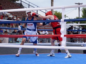 Supplied Photo
Kingston Youth Boxing Club's John D. Firth lands a punch during a light-heavyweight bout against Gouverneur, N.Y., boxer John Tulley at the Gouverneur and St. Lawrence County Fair on Saturday. Firth won the match by split decision.