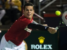 Milos Raonic returns to Ivo Karlovic during second round of play at the Rogers Cup in Montreal on Tuesday, Aug. 11, 2015. (Paul Chiasson/THE CANADIAN PRESS)