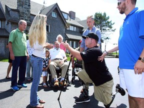 In this Monday, Aug. 10, 2015 photo provided by the office of former President George H.W. Bush, Army Spc. Tyler Jeffries proposes to Lauren Lilly at the Bush summer home in Kennebunkport, Maine. Former Presidents George H.W. Bush, his son George W. Bush and their first ladies witnessed the proposal. (Office of George H.W. Bush via AP)