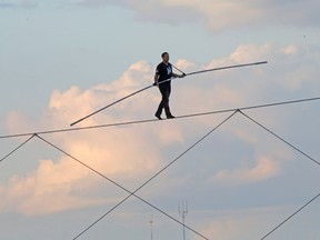 High-wire daredevil Nik Wallenda walks a tightrope above the  Milwaukee Mile Speedway at the Wisconsin State Fair in West Allis, Wis., on Aug. 11, 2015. Wallenda completed his longest tightrope walk ever during the appearance at the Wisconsin State Fair. (Mike De Sisti/Milwaukee Journal-Sentinel via AP)