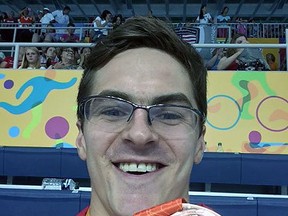 Para-swimmer Gordie Michie proudly displays the bronze medal he won at the Toronto 2015 Parapan Am Games in the men's S14 200-metre freestyle event. The swimmer went on to win gold in the 100-metre backstroke event on Monday evening.