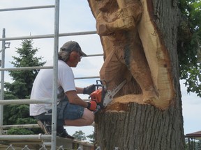Carving artist Kane Sibley of Mount Brydges working on his second tree sculpture in the municipality on Thursday, Aug. 6.