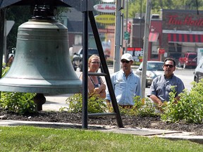 Communities in Bloom volunteer Julie Van Damme, left, shows off the new gardens around the bell at Wallaceburg's Civic Square Park to Community in Bloom judges Alain Cappelle and Richard Daigneault on July 29. Wallaceburg councillor Carmen McGregor, far right, also looks on.