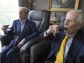 The world's oldest living twin brothers, Paulus (L) and Pieter Langerock from Belgium, 102, drink wine while sitting in their living room at the Ter Venne care home in Sint-Martens-Latem, Belgium, August 11, 2015. Born on July 8 1913, they never married and until this day sleep side by side in the same room. Eating in moderation, drinking a glass of good wine every day and avoiding chasing women are the secrets of a long life, Belgians Pieter and Paulus Langerock, the world's oldest living twin brothers, say. The brothers have lived together for most of their lives and until this day barely leave each other's side, sharing a room at their nursing home just outside the Belgian town of Ghent. Picture taken August 11, 2015. REUTERS/Yves Herman