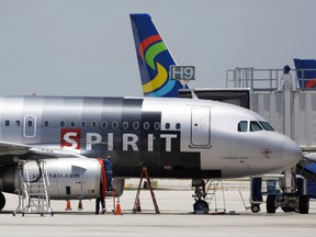 In this file photo taken June 13, 2010, a Spirit Airlines airplane sits on the tarmac at Fort Lauderdale-Hollywood International Airport in Fort Lauderdale, Fla.  (AP Photo/Lynne Sladky, File)