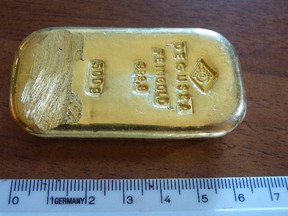 The photo released by the police in Rosenheim on Aug. 12, 2015 shows a gold bar that was found by a teenager when swimming in a lake near Berchtesgaden. Police said in a statement that they still try to find out from where the 500g (17.6-ounce) bar came.  (Polizeipraesidium Oberbayern Sued via AP)