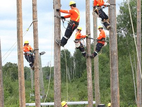 Participants take part in a training session in the Line Crew Ground Support Training program at the powerline training field at Cambrian College in Sudbury, Ont. on Tuesday August 11, 2015. The 15-week program, which is for Aboriginal students, is a partnership between Infrastructure Health and Safety Association, Gezhtoojig Employment and Training and Cambrian College. John Lappa/Sudbury Star/Postmedia Network