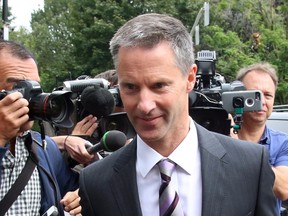 Nigel Wright, former chief of stall to Prime Minister Stephen Harper, makes his way through a crush of media as he arrives to testify at the criminal trial of embattled Sen. Mike Duffy in Ottawa Wednesday, August 12, 2015. THE CANADIAN PRESS/Fred Chartrand