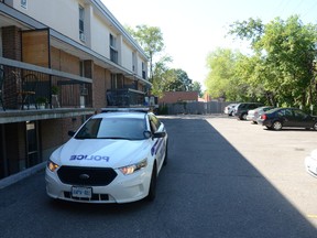 A police car sits outside 2176 Blossom Dr.,  where Ottawa cops say a stabbing occurred early on Sunday, Aug. 9, 2015. three people were stabbed, and cops seek 4 suspects. SAM COOLEY/Ottawa Sun
