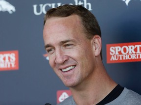 Denver Broncos quarterback Peyton Manning jokes with reporters after the morning session at the team's NFL football training camp Wednesday, Aug. 12, 2015, in Englewood, Colo. (AP Photo/David Zalubowski)