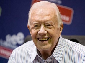 In this July 10, 2015, file photo, former President Jimmy Carter poses for photographs at an event for his new book "A Full Life: Reflections at Ninety at the Free Library in Philadelphia. Carter is expected to make a full recovery after having an operation Monday, Aug. 3, to remove a small mass in his liver, according to a spokeswoman. (AP Photo/Matt Rourke, File)