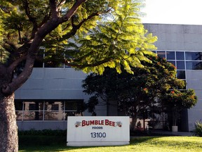 This Monday, Oct. 15, 2012 file photo shows the Bumble Bee tuna processing plant in Santa Fe Springs, Calif. Bumble Bee Foods has agreed to pay $6 million Wednesday, Aug. 12, 2015, to settle criminal charges in the death of a Los Angeles-area worker who was cooked in an oven with tons of tuna. (AP Photo/Nick Ut, File)
