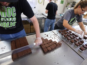 FILE - In this Sept. 26, 2014, file photo, smaller-dose pot-infused brownies are divided and packaged at The Growing Kitchen in Boulder, Colo. Edible marijuana products in Colorado may soon come labeled with a red stop sign as the state is finalizing work on new rules for the appearance of edible marijuana. A draft of those rules released Tuesday, Aug. 11, 2015, would require each piece of edible marijuana to be marked in the shape of a stop sign with the letters THC in the middle. The letters stand for marijuana's psychoactive ingredient. (AP Photo/Brennan Linsley, File)