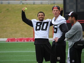 Ottawa RedBlacks receiver Chris Williams stands on the sidelines with teammate Matt Carter during practice Wednesday at TD Place. (TIM BAINES/OTTAWA SUN)