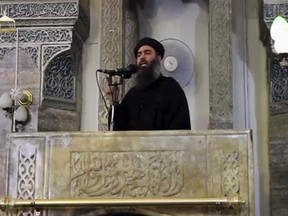 A man purported to be the reclusive leader of the militant Islamic State Abu Bakr al-Baghdadi is seen in what would have been his first public appearance at a mosque in the centre of Iraq's second city, Mosul, according to a video recording posted on the Internet on July 5, 2014, in this file still image taken from video. REUTERS/Social Media Website via Reuters TV/Files