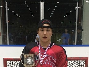 Greater Sudbury's Felix Cote poses with the championship trophy after helping Team Ontario win the national title in July.