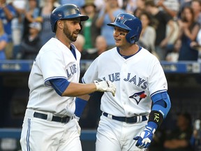 Blue Jays designated hitter Chris Colabello (left) celebrates with shortstop Troy Tulowitzki (right) after hitting a three-run home run against the Athletics in the first inning in Toronto on Wednesday, Aug. 12, 2015. (Dan Hamilton//USA TODAY Sports)