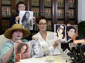 Colleen Hughes (L) Linda Ridgeway Whitedeer (C), two new alleged sexual assault victims of comedian Bill Cosby, and Eden Tirl (R), who is accusing Cosby of sexual harassment, hold up their photographs during the time of the alleged sexual assault at a news conference with Attorney Gloria August 12, 2015, in Los Angeles, California. Cosby has been accused of sexual assault by over 30 women.  Kevork Djansezian/Getty Images/AFP