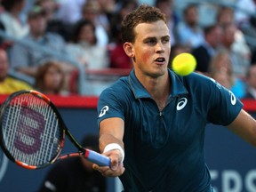 Vasek Pospisil hits a shot against John Isner during the Rogers Cup at Uniprix Stadium in Montreal on Wednesday, Aug. 12, 2015. (Jean-Yves Ahern/USA TODAY Sports)