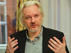 WikiLeaks founder Julian Assange gestures during a news conference at the Ecuadorian embassy in central London, Britain, in this Aug. 18, 2014 file photo. (REUTERS/John Stillwell/pool)