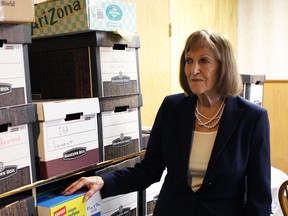 Ruth Adria, founder of the Elder Advocates of Alberta Society, looks over stacks of boxed filled with case files documenting allegations of abuse, neglect and maltreatment of Alberta's seniors in Edmonton on Aug. 10, 2015. Claire Theobald/Edmonton Sun/Postmedia Network