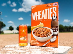 This undated photo provided by General Mills shows a box of Wheaties cereal next to a can of limited-edition HefeWheaties beer. Wheaties said it is partnering with a craft brewery to make the beer. (General Mills via AP)