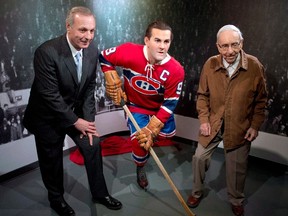 Former Montreal Canadiens Guy Lafleur, left, and Bob Fillion, 94, who won the Stanley Cup with the Richard in 1944 and 1945, pose with the new wax statue of Maurice 'Rocket' Richard at the unveiling of a at the Montreal Canadiens Hall of Fame in Montreal on April 10, 2014. (THE CANADIAN PRESS/Ryan Remiorz)