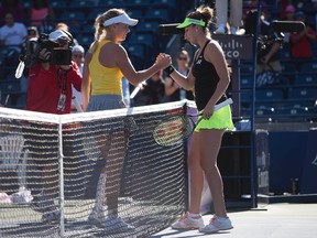 Belinda Bencic (right) shakes hands with Caroline Wozniacki (left) at the end of their match during the second round of the Rogers Cup in Toronto on Wednesday, Aug. 12, 2015. (Nick Turchiaro/USA TODAY Sports)