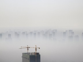 A building under construction is seen amidst smog on a polluted day in Shenyang, Liaoning province in this November 21, 2014 file photo. (REUTERS/Jacky Chen/Files)