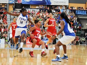 Canada's Miah-Marie Langlois controls the ball while surrounded by Cuba players during Thursday's game. (A.J. Lawrence/FIBA Americas)