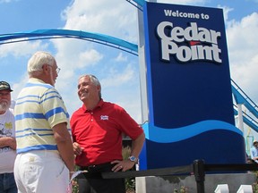 In this July 2, 2014, file photo, Matt Ouimet, chief executive of Cedar Fair Entertainment Co., greets a guest at Cedar Point amusement park, in Sandusky, Ohio. A man who entered a restricted area at the amusement park to look for a lost cellphone has been struck by a roller coaster and killed on Aug. 13, 2015. (AP Photo/John Seewer, File)