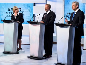 Liberal leader Justin Trudeau (L), Green Party leader Elizabeth May (2nd L) and New Democratic Party leader Thomas Mulcair listen as Conservative Leader Stephen Harper (R) speaks during the first leaders' debate in Toronto Aug. 6, 2015. REUTERS/Frank Gunn/Pool