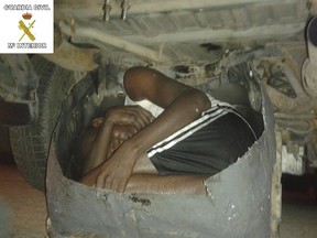 A young African man, who squeezed into a tiny hidden compartment in a car to try to enter Spanish North African city of Melilla, is seen in this handout picture released by Spain's Interior Ministry on Aug. 14, 2015. (REUTERS/Spanish Interior Ministry/Handout via Reuters)