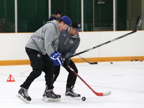Sudbury Wolves rookies Dmitri Sokolov (left) and David Levin battle for the puck during the Wolves' hockey school at Gerry McCrory Countryside Arena on Tuesday. The duo have become fast friends.
