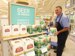 Gilles Barbe, assistant manager of the LCBO on Marcus Drive in Sudbury, Ont., stocks shelves with 12-packs of beer on Friday August 14, 2015. John Lappa/Sudbury Star/Postmedia Network